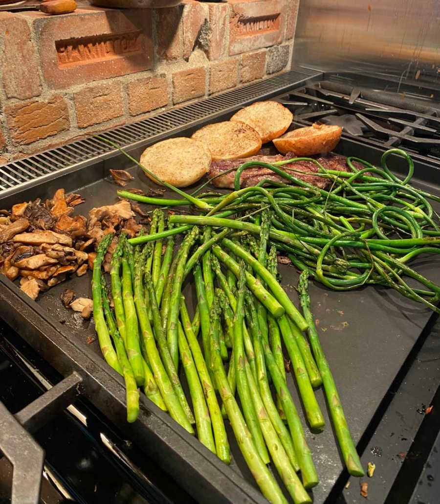 Grilling garlic scapes whole on medium high heat for 5 or so minutes, at Tree House Kitchen.