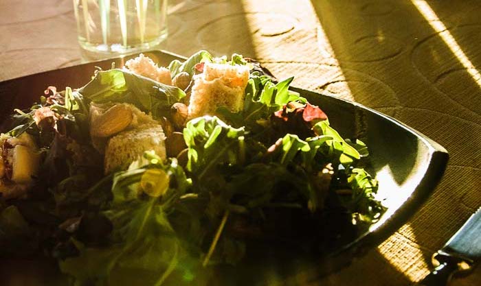 Close-up on a leafy green salad topped with homemade croutons.