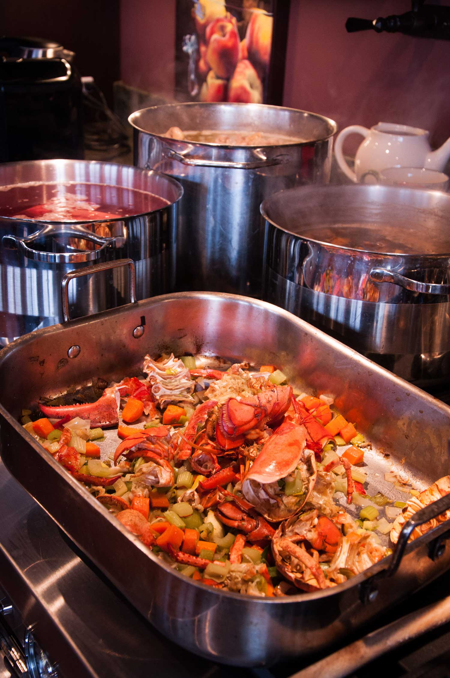 A variety of stocks simmering on a stovetop in Tree House Kitchen.