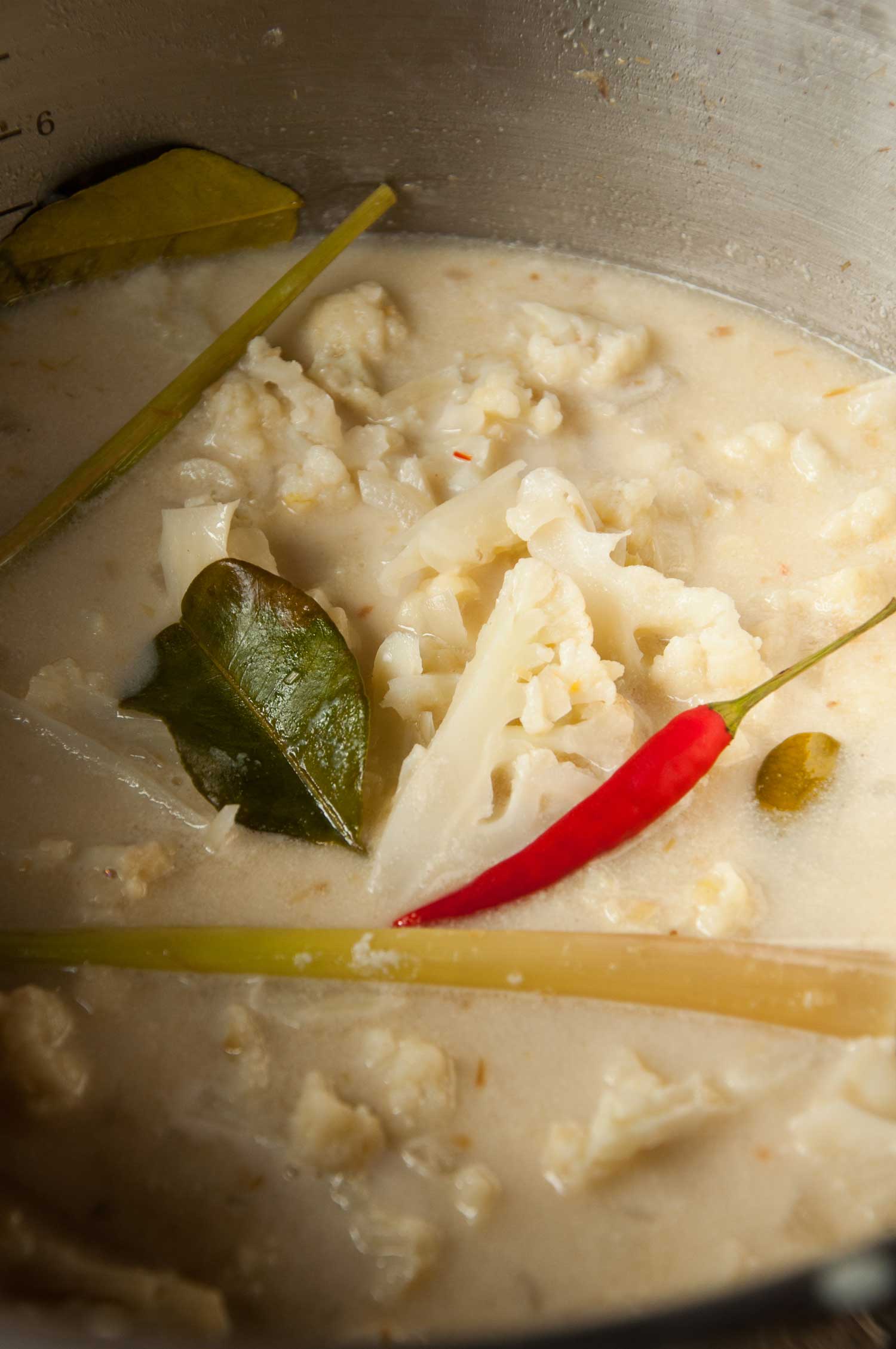 Creamy coconut milk soup with chunks of cauliflower, red chili peppers, lemongrass and lime leaves. 