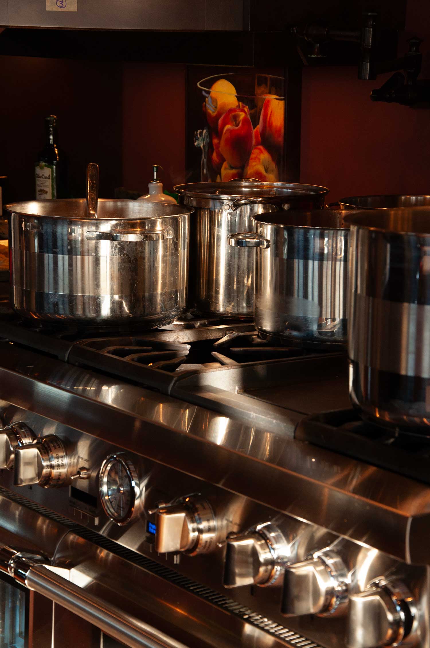 A collection of large pots on a stovetop.