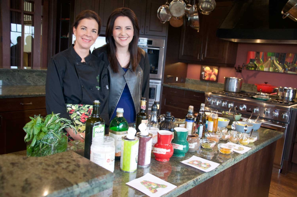 Reporter Danielle de Graauw of Cable 14 TV creating vinaigrettes with Chef Henley.